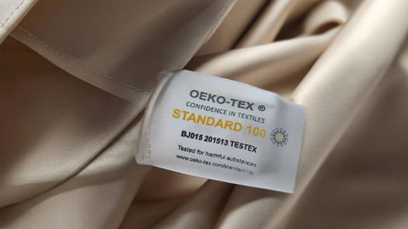 Eco-certified silk fabric with OEKO-TEX label used in sustainable custom sleepwear manufacturing and silk pajamas production