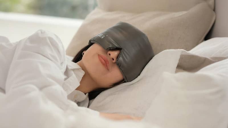 Luxury spa guest using a customized silk sleep mask with hotel logo, enhancing the spa branding experience